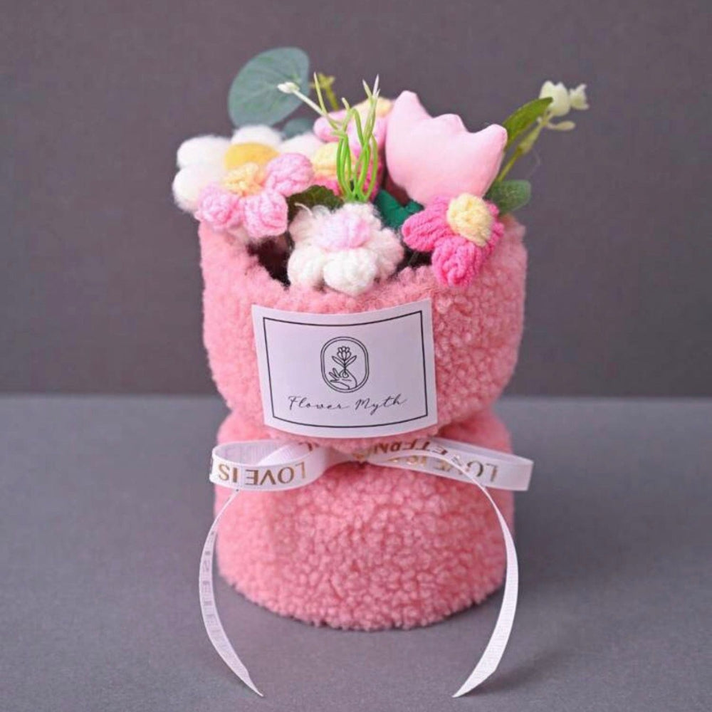 Pink textured gift with flowers and a label on a gray background