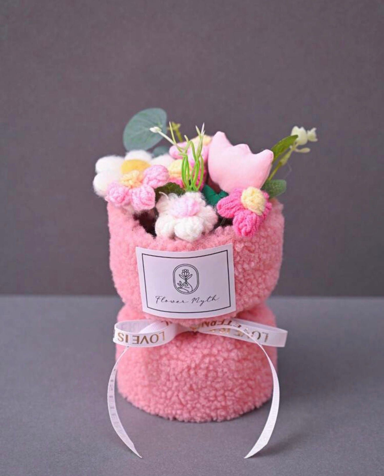 Pink bouquet with decorative elements on a gray background