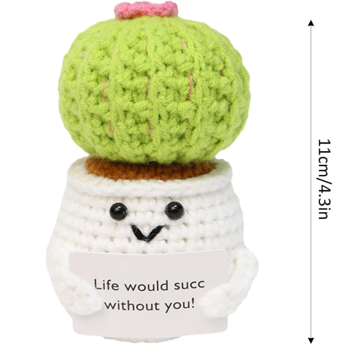 Knitted cactus plant with a smiling face and message 'Life would succ without you!' on a white background.