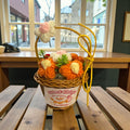 Wicker basket with knitted flowers on a wooden table in a cafe setting