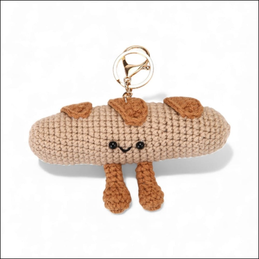Crocheted dog-shaped keychain on a white background