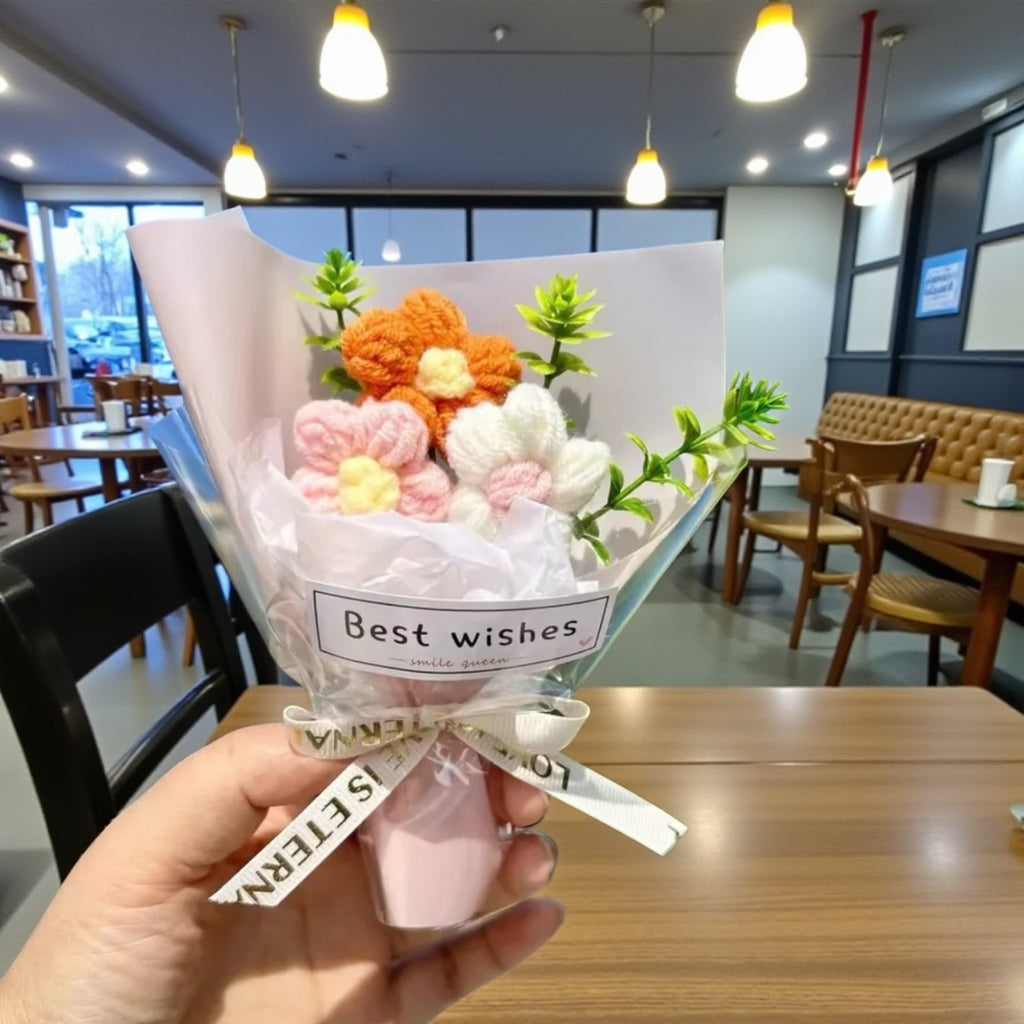 Bouquet of decorative flowers with 'Best wishes' text held in a restaurant setting