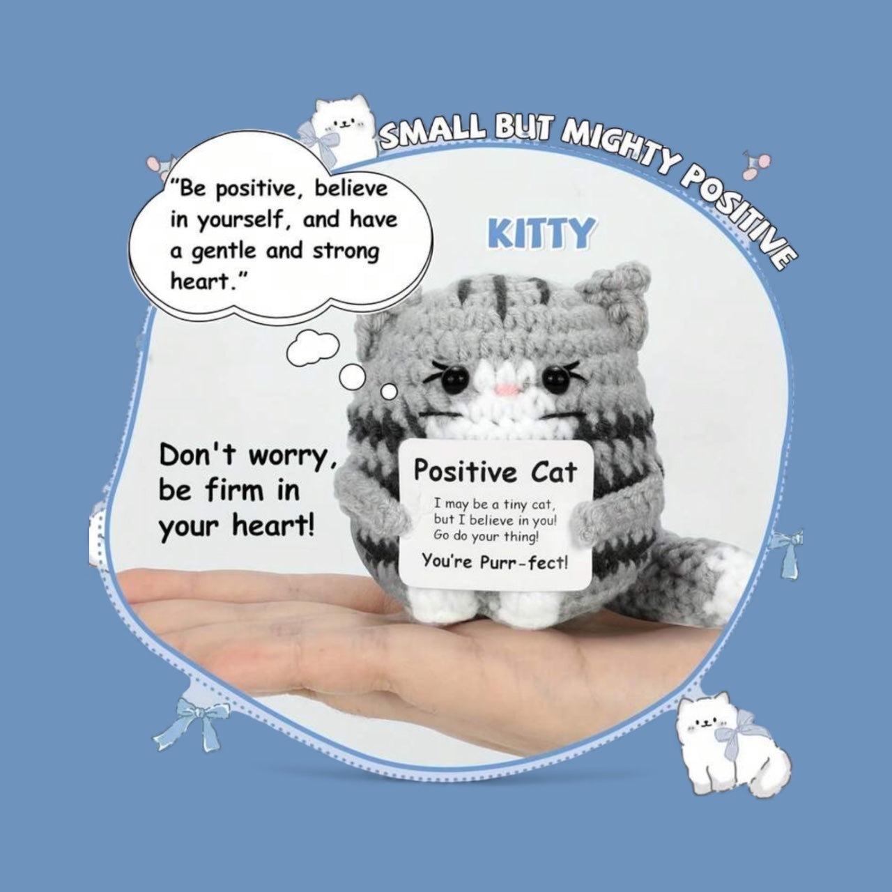 Crocheted cat plush toy with motivational text on a blue background
