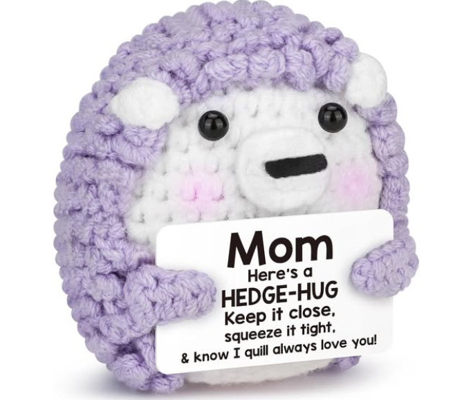 Plush hedgehog toy with a message card on a white background