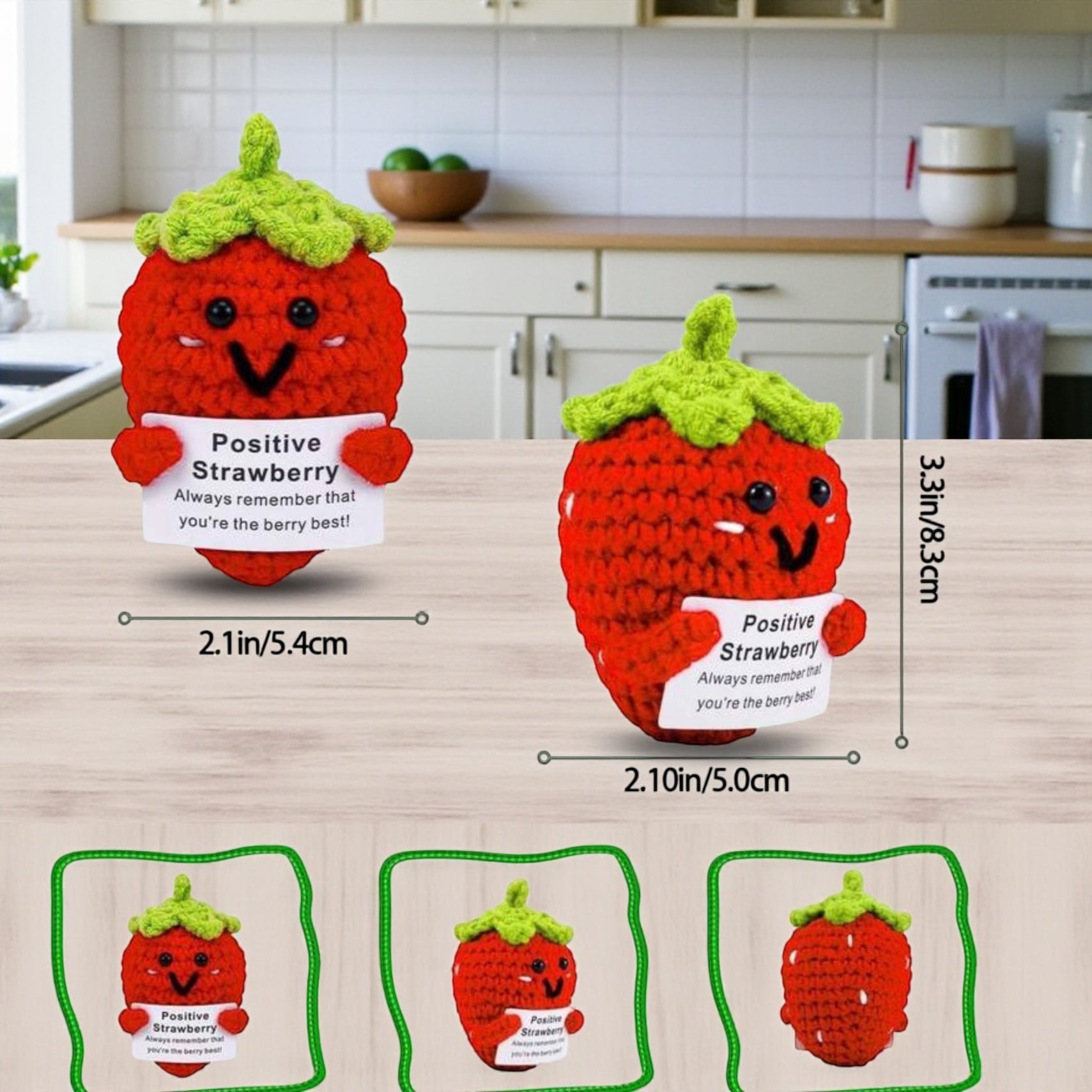 Two crochet strawberry characters with a smiling face on a kitchen counter, showing measurements.