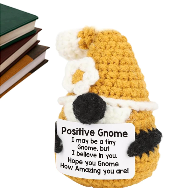 Crocheted gnome with a sign reading 'Positive Gnome' on a white background