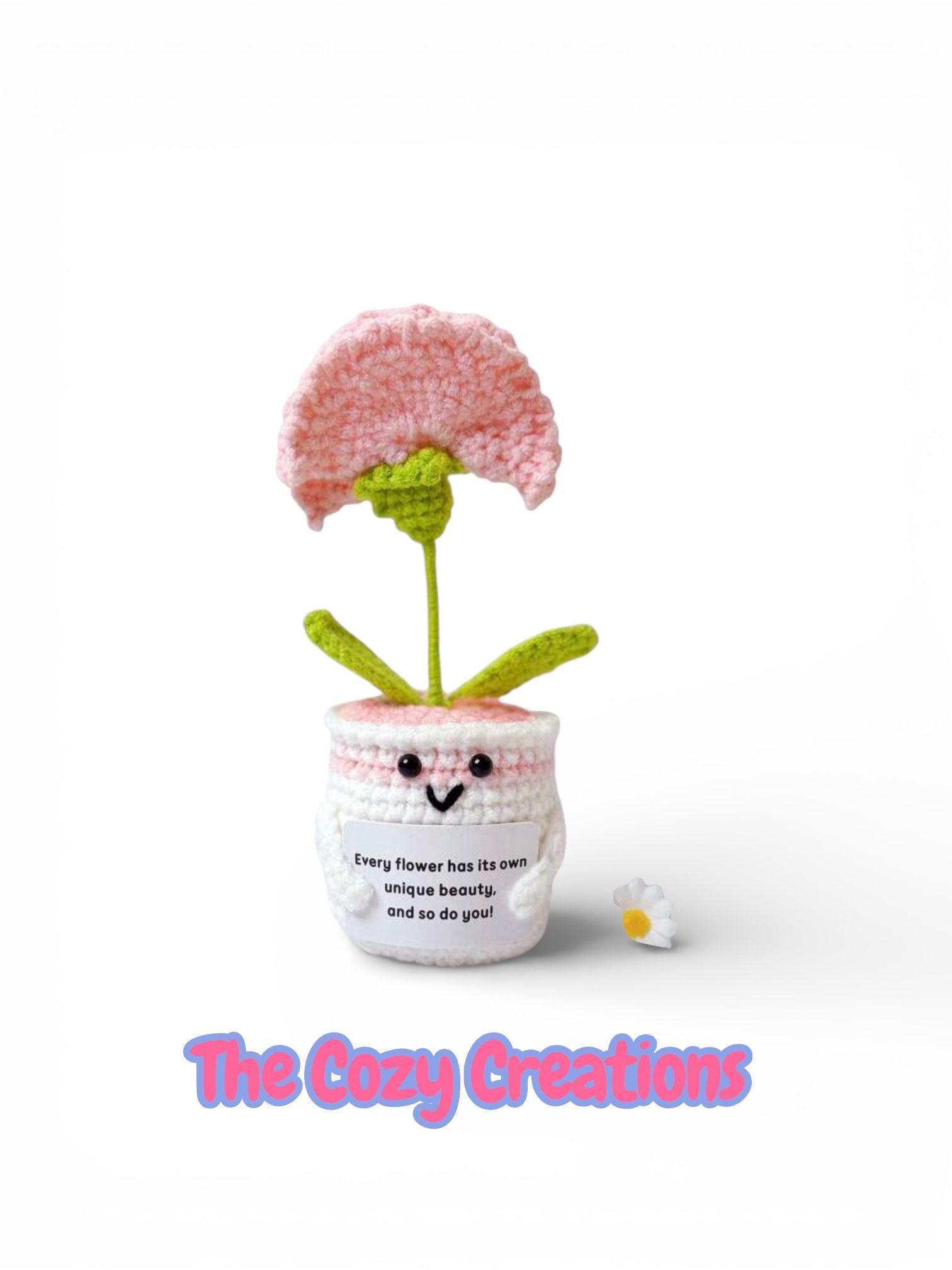 Crocheted flower pot with pink flower on a white background, featuring 'The Cozy Creations' branding.