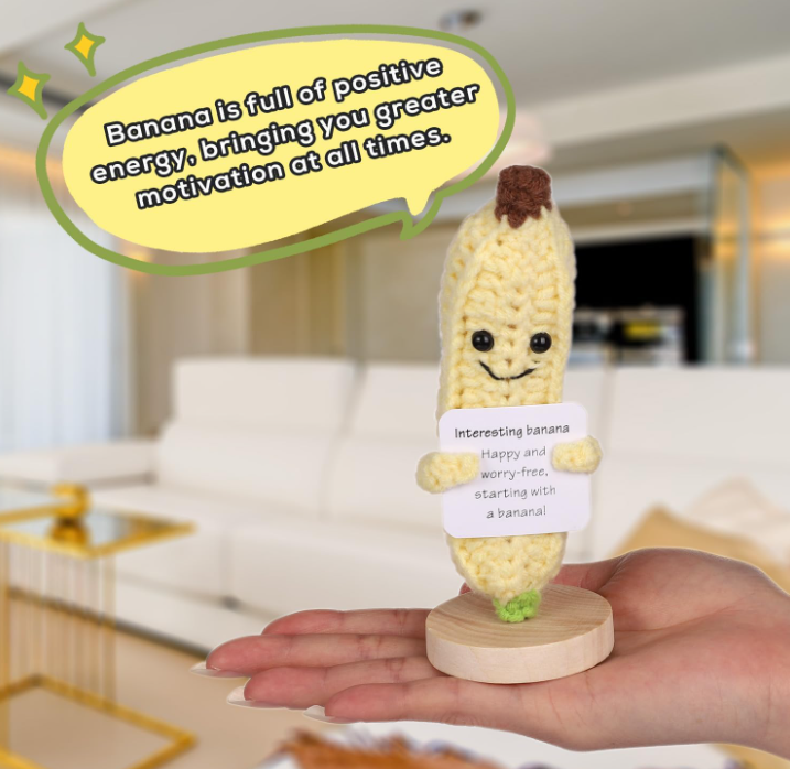 Toy banana figure with a speech bubble and text in a living room setting