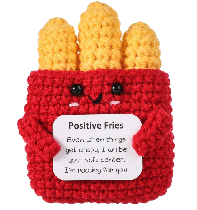 Crocheted French fry holder with a face and a positive message on a white background