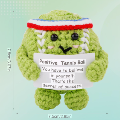 Green plush toy with a message sign and measurement details on a light green background