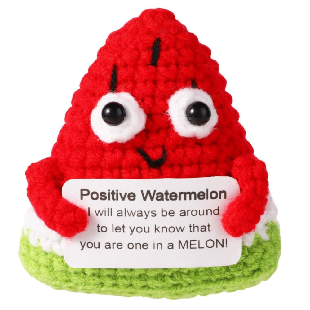 Crocheted watermelon character with a message on a white background