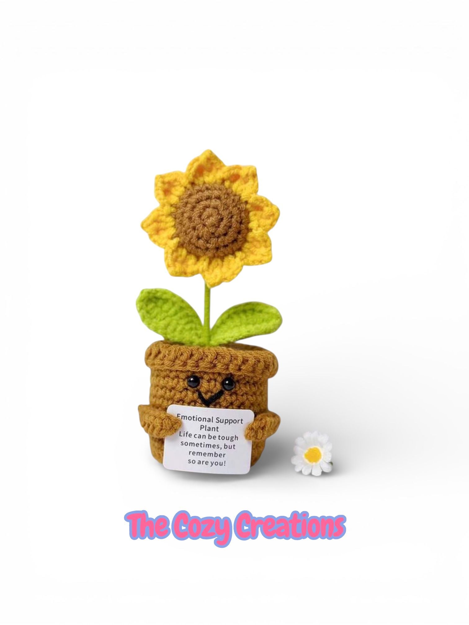 Crocheted sunflower in a pot with a small card, on a white background with 'The Cozy Creations' branding.