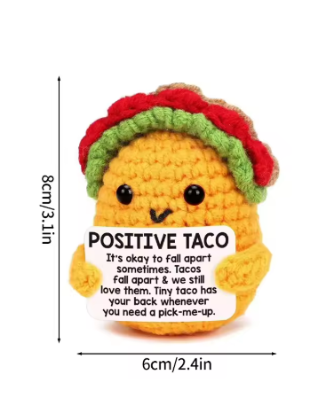 Crocheted taco plush toy with a label and measurements on a white background